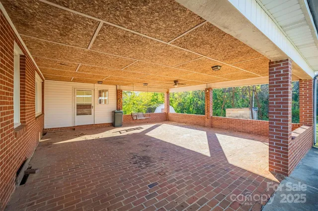 a view of interior space with wooden floor and fence