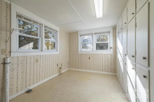a view of an empty room with a window