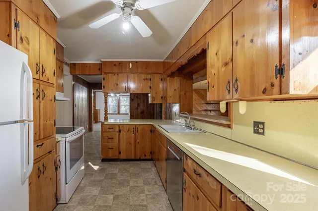 a kitchen with stainless steel appliances granite countertop a sink and cabinets