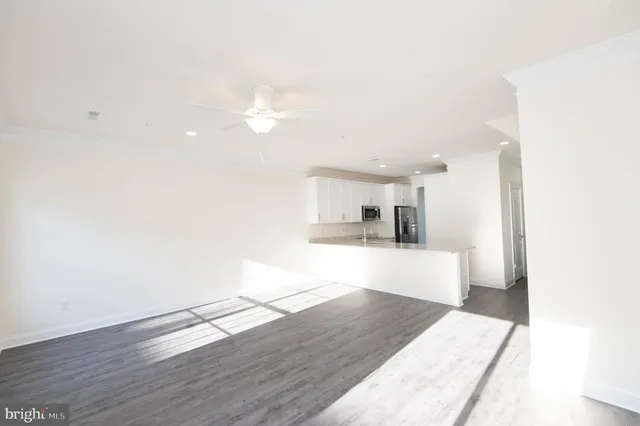 a kitchen with granite countertop a sink and white cabinets