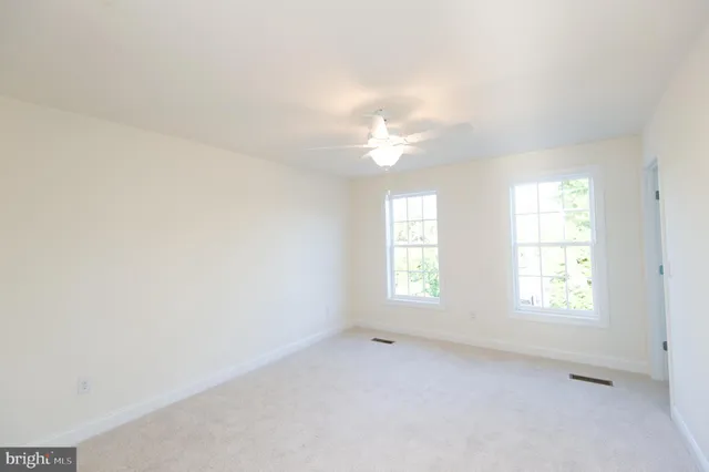a bathroom with a granite countertop sink a toilet and bathtub