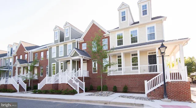 a front view of a house with a tree