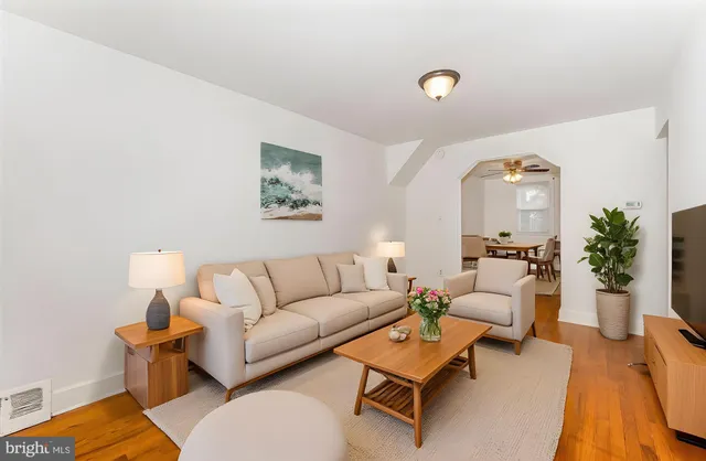 a living room with furniture and wooden floor