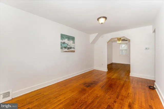 a view of a livingroom with wooden floor and windows