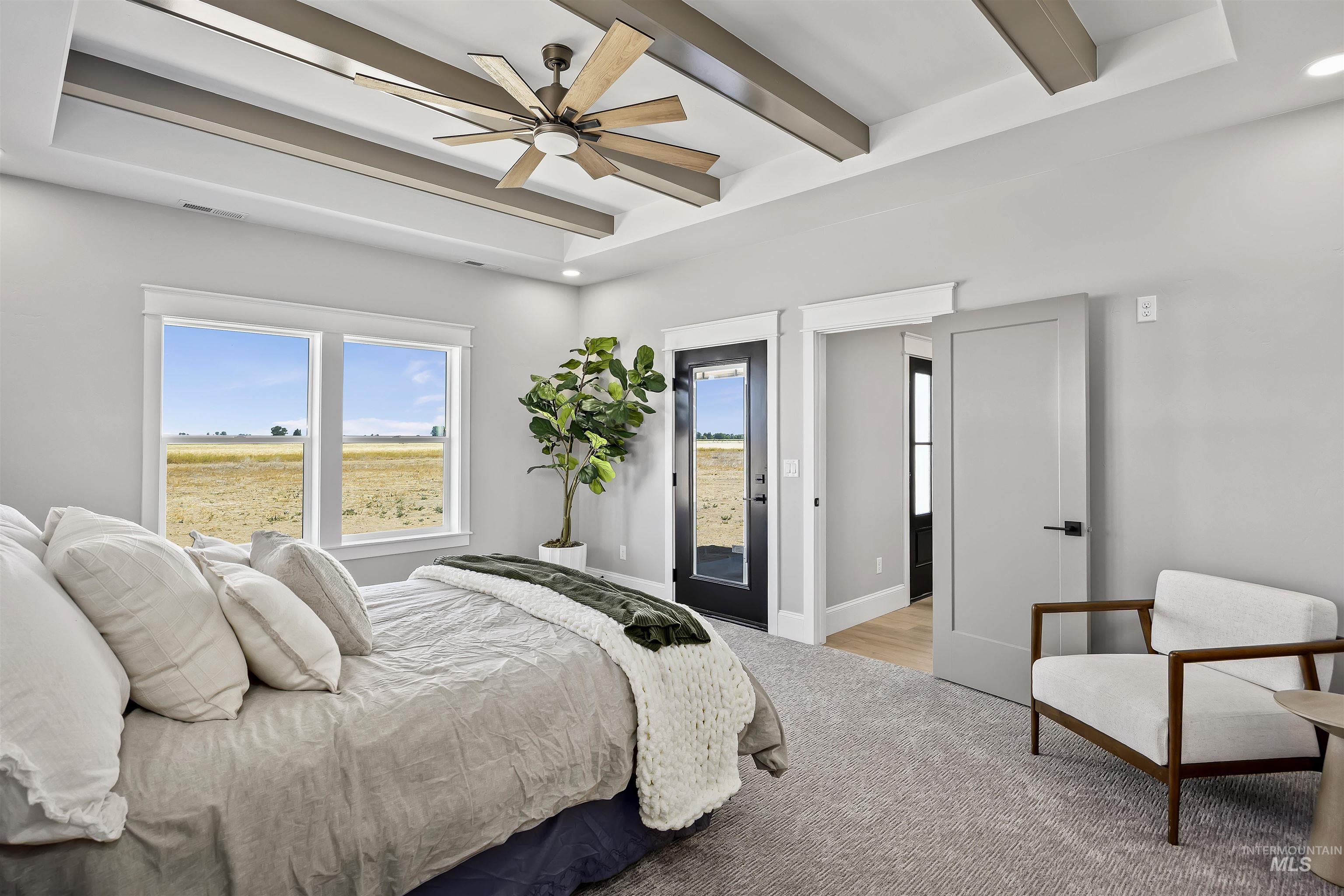 378 West 100 South Rupert, ID 83350 - Photo 23 of 50 Coffered ceiling with a modern ceiling fan, large windows, light gray walls, gray carpet flooring, and a modern interior door with matte black hardware