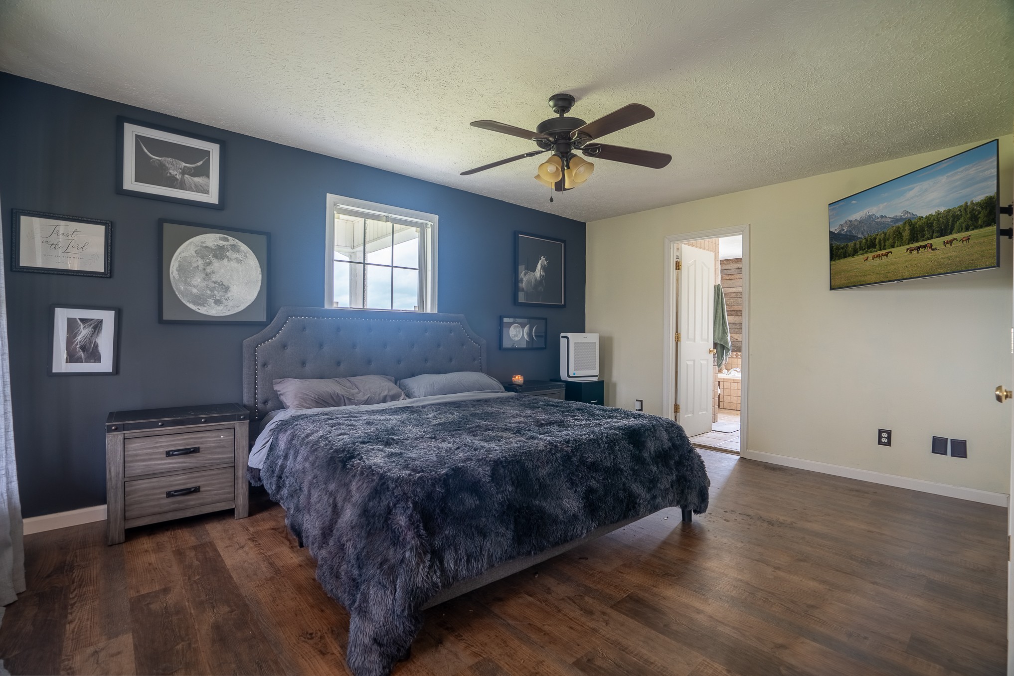 11220 Shelbyville Road Morrison, TN 37357 - Photo 21 of 67 a bedroom with a bed and a chandelier