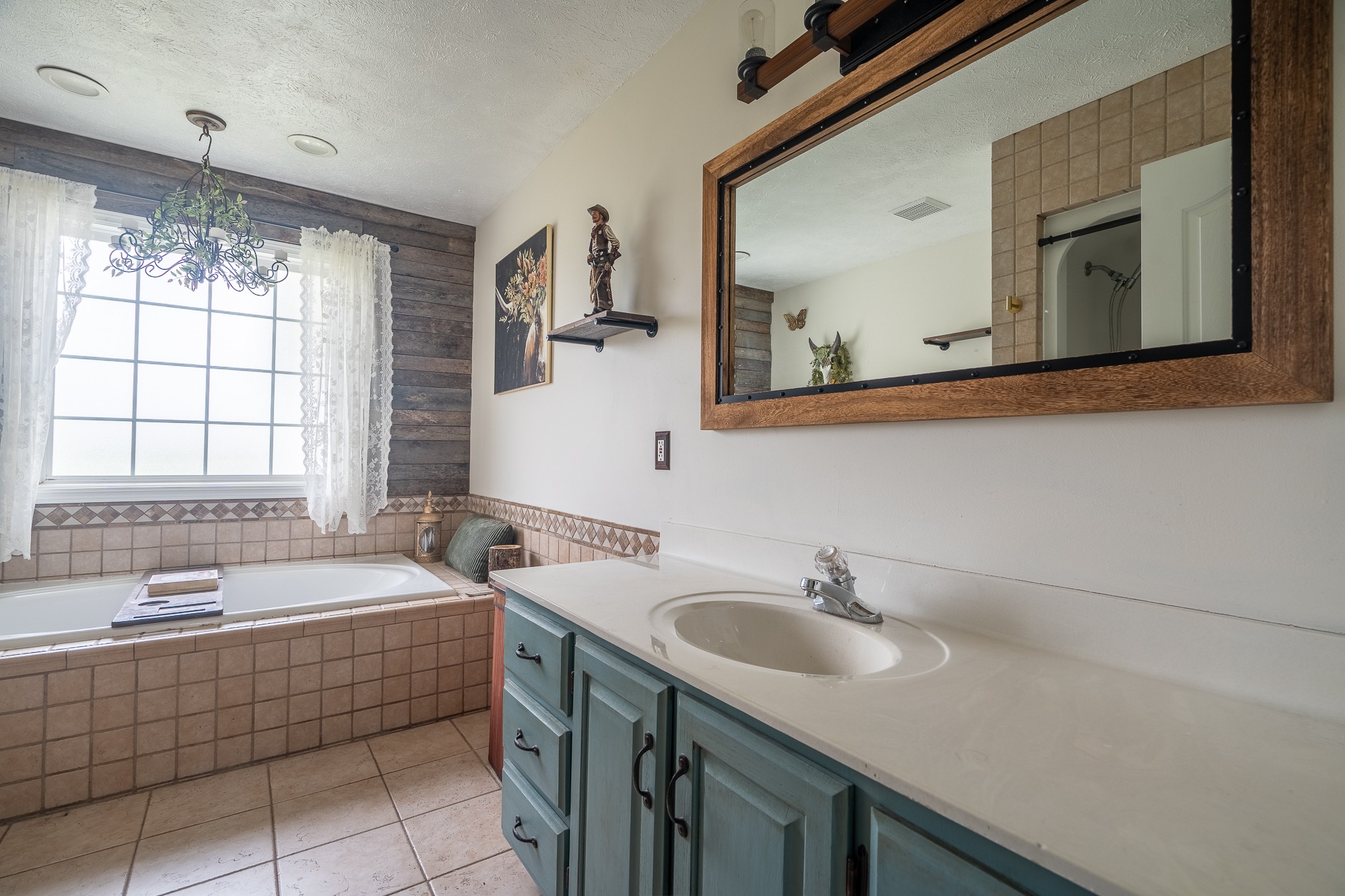 11220 Shelbyville Road Morrison, TN 37357 - Photo 23 of 67 a bathroom with a tub double sink window and mirror