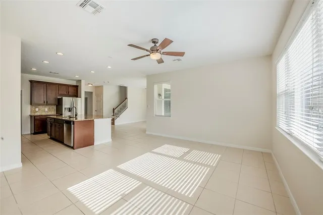 a living room with furniture and kitchen view