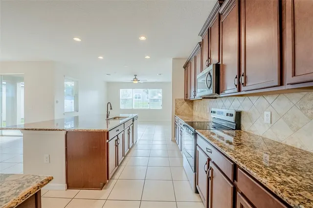a kitchen with stainless steel appliances granite countertop a sink and cabinets