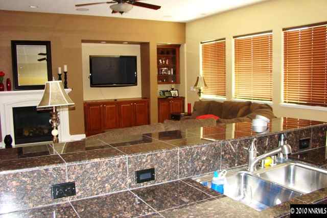 10550 Kenai Drive Reno, NV 89521 - Photo 3 of 9 a living room with fireplace furniture and a flat screen tv