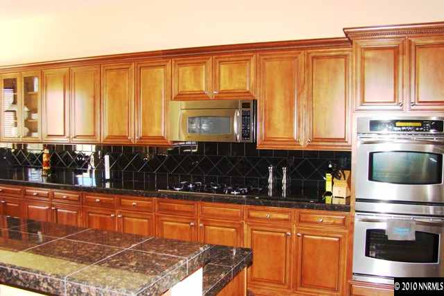 10550 Kenai Drive Reno, NV 89521 - Photo 4 of 9 a kitchen with stainless steel appliances granite countertop a stove a sink and a microwave