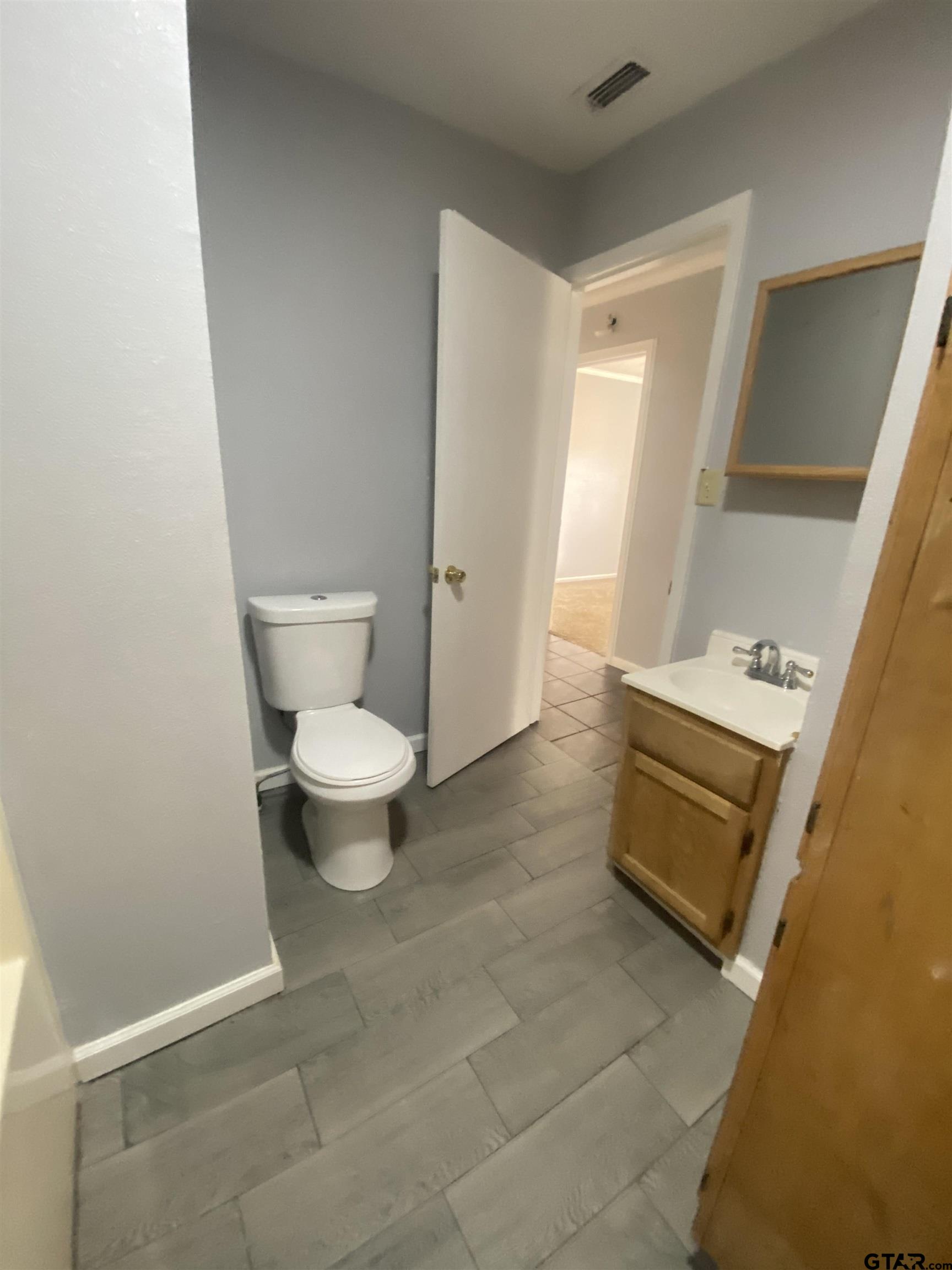 23601 State Highway 64 Troup, TX 75789 - Photo 13 of 19 a bathroom with a toilet and a sink