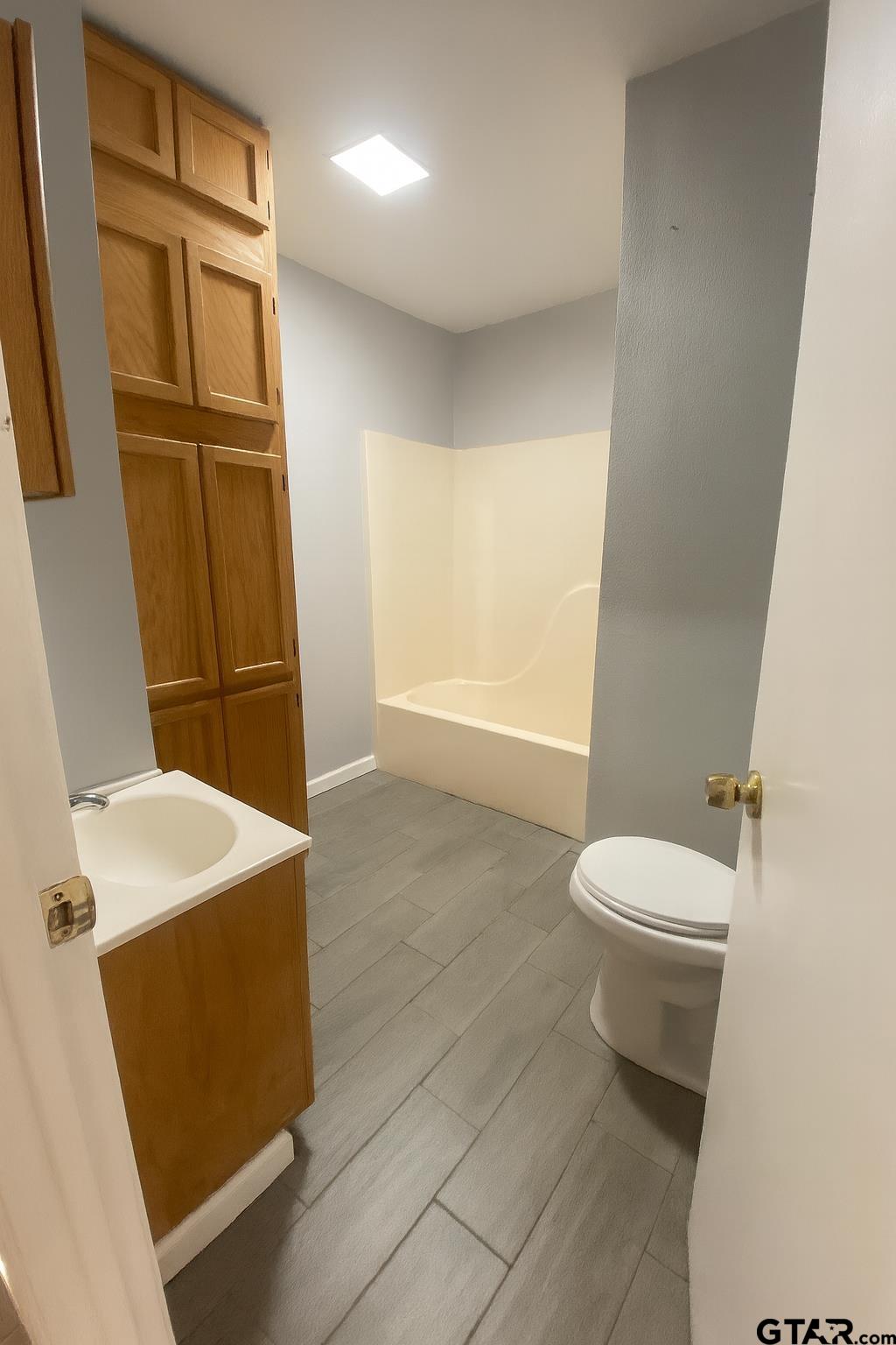 23601 State Highway 64 Troup, TX 75789 - Photo 14 of 19 a bathroom with a sink a toilet and tub