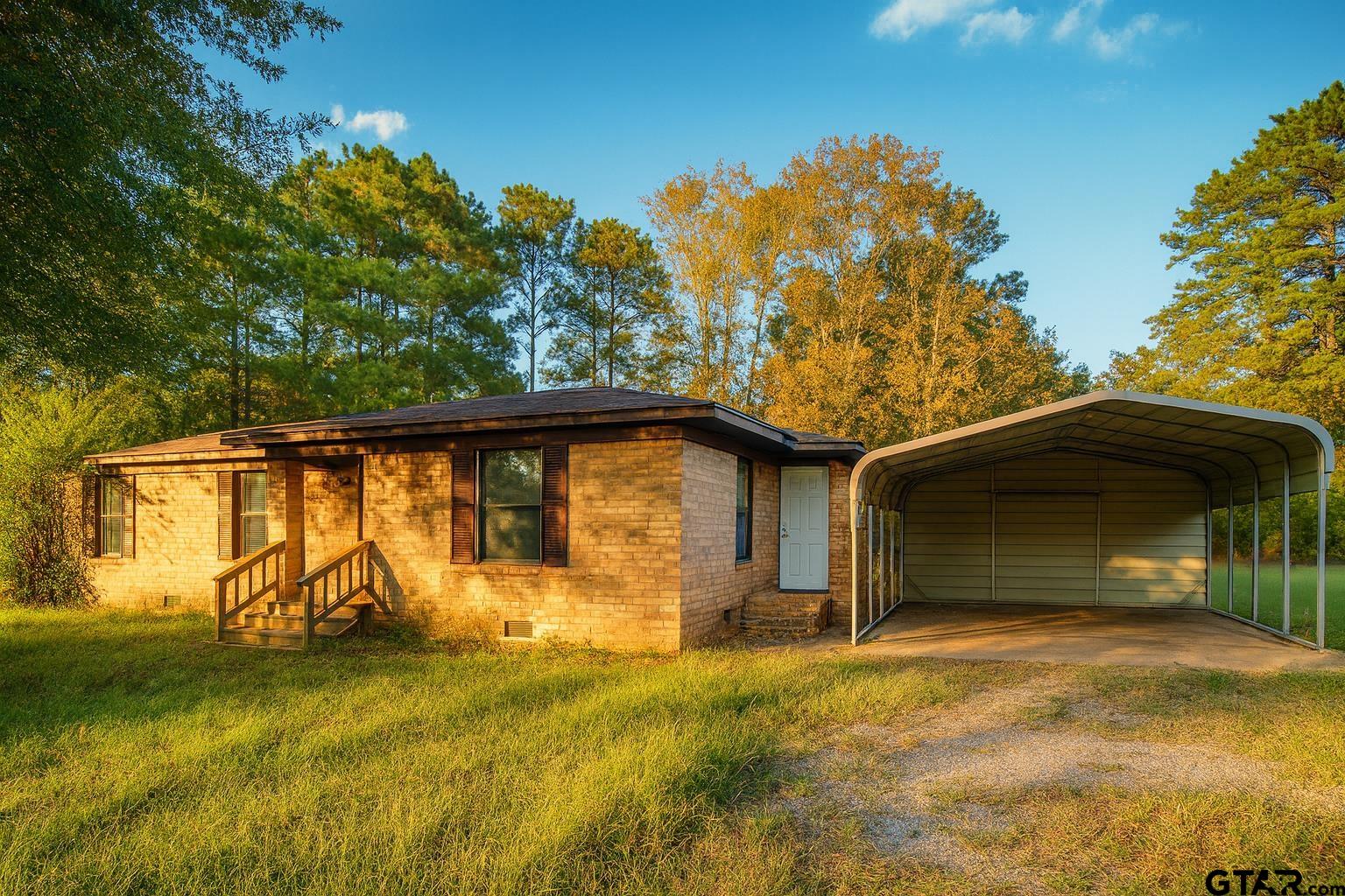 23601 State Highway 64 Troup, TX 75789 - Photo 2 of 19 a front view of a house with garden