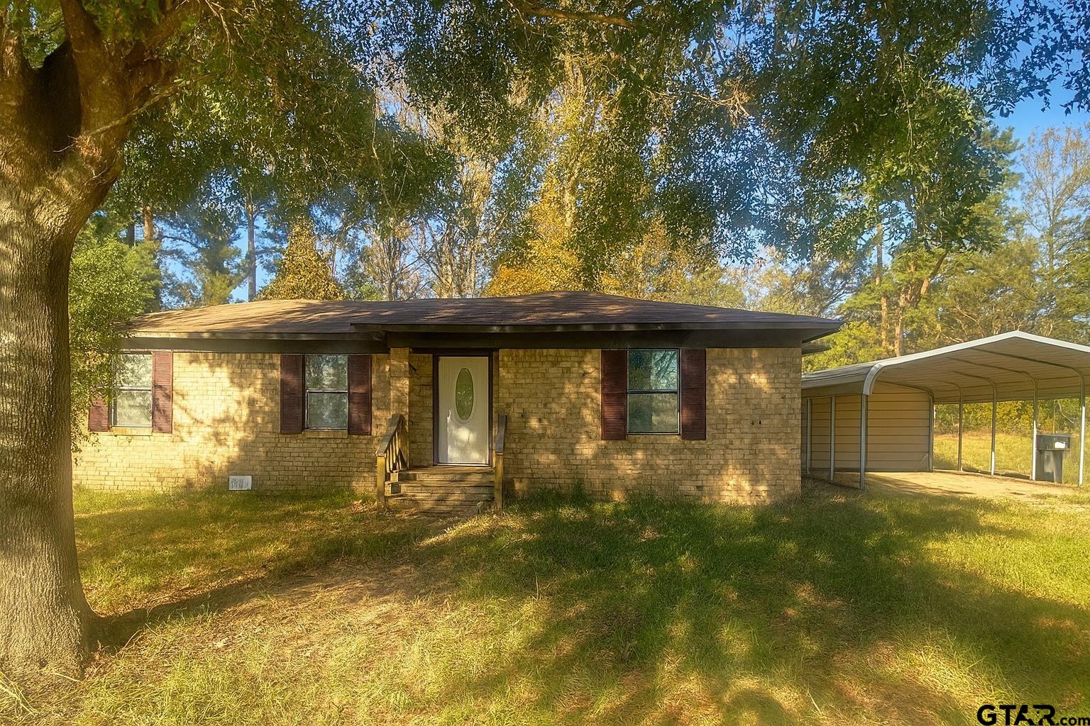 23601 State Highway 64 Troup, TX 75789 - Photo 4 of 19 a front view of a house with a yard
