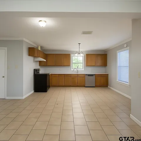 a kitchen with granite countertop a sink and cabinets