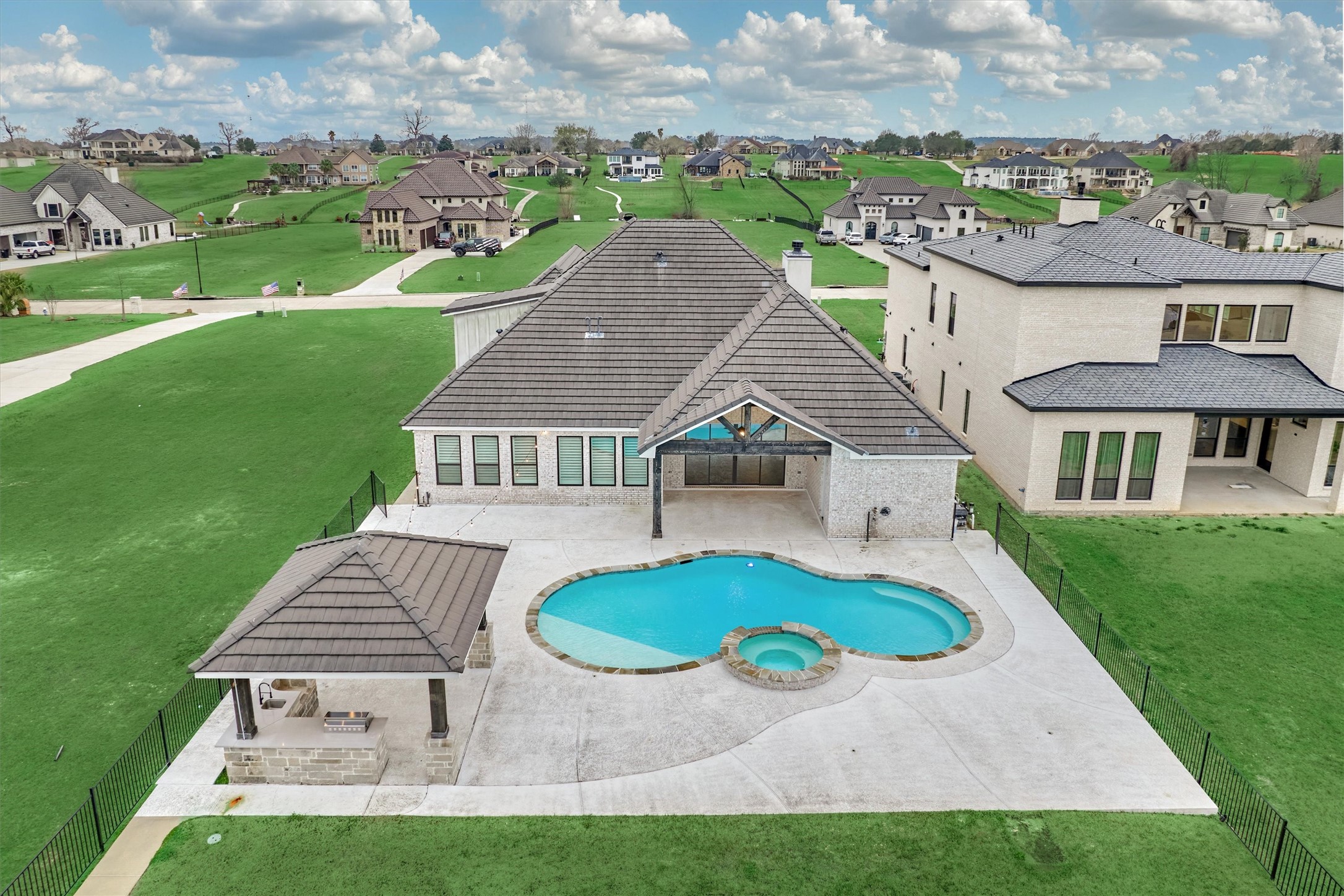 11618 Renaissance Drive Montgomery, TX 77356 - Photo 37 of 49 Expansive pool decking provides ample space for multiple seating and lounging areas, ideal for entertaining or relaxing poolside.