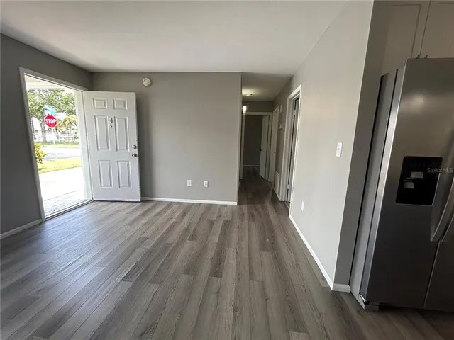 a view of hallway with wooden floor and stairs