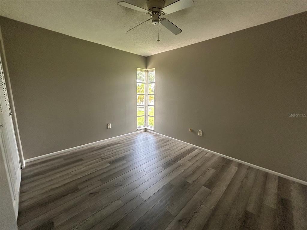 8521 Pickwick Road North Port, FL 34287 - Photo 16 of 19 an empty room with a ceiling fan and window