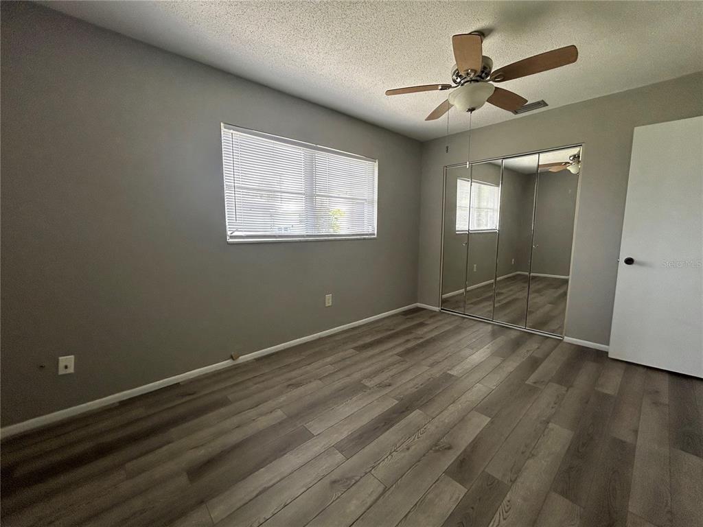 8521 Pickwick Road North Port, FL 34287 - Photo 18 of 19 an empty room with wooden floor and windows