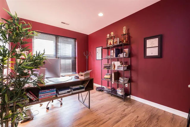 a workspace with furniture window and wooden floor