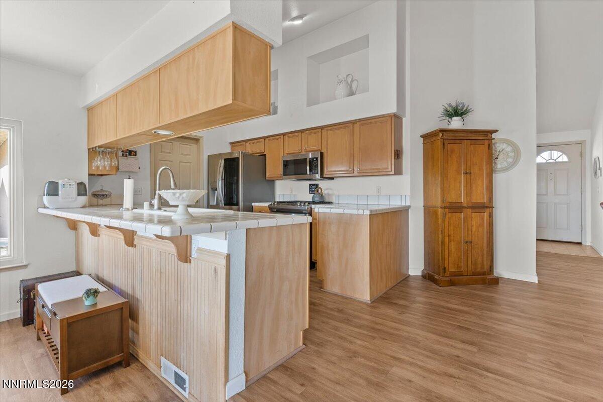 9580 Benedict Drive Sparks, NV 89441 - Photo 14 of 40 a kitchen with stainless steel appliances granite countertop a refrigerator a stove and a sink
