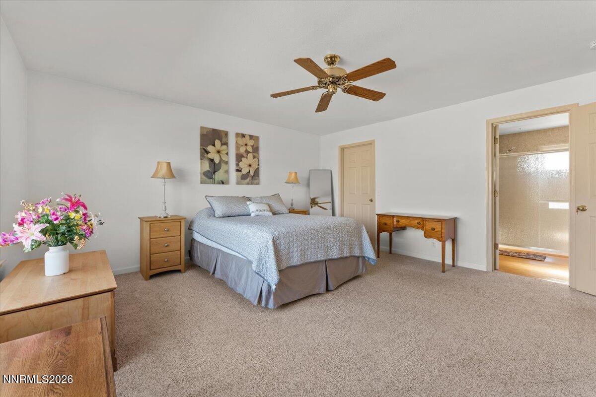 9580 Benedict Drive Sparks, NV 89441 - Photo 21 of 40 a bedroom with a bed and a chandelier
