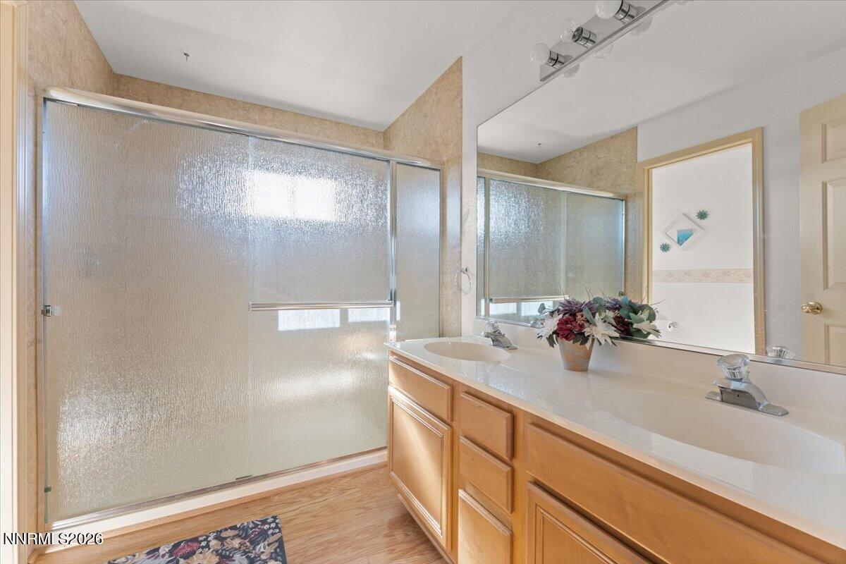 9580 Benedict Drive Sparks, NV 89441 - Photo 22 of 40 a bathroom with a double vanity sink and a mirror