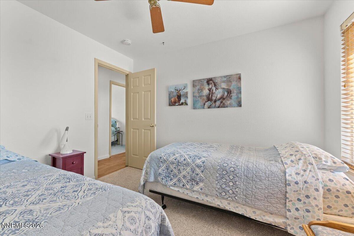 9580 Benedict Drive Sparks, NV 89441 - Photo 26 of 40 a bedroom with a bed and a painting on the wall