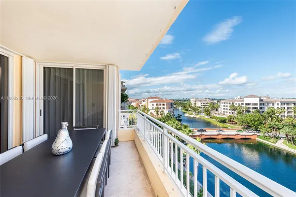 a living room with furniture a large window and a table