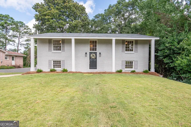 front view of house with yard and trees