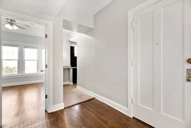 a view of a hallway with wooden floor