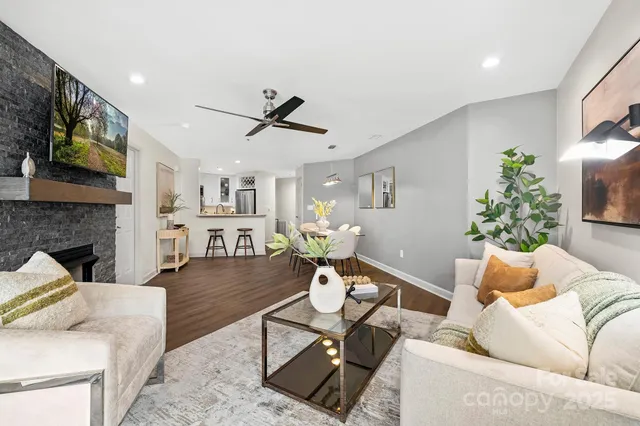 a living room with furniture a fireplace and a flat screen tv