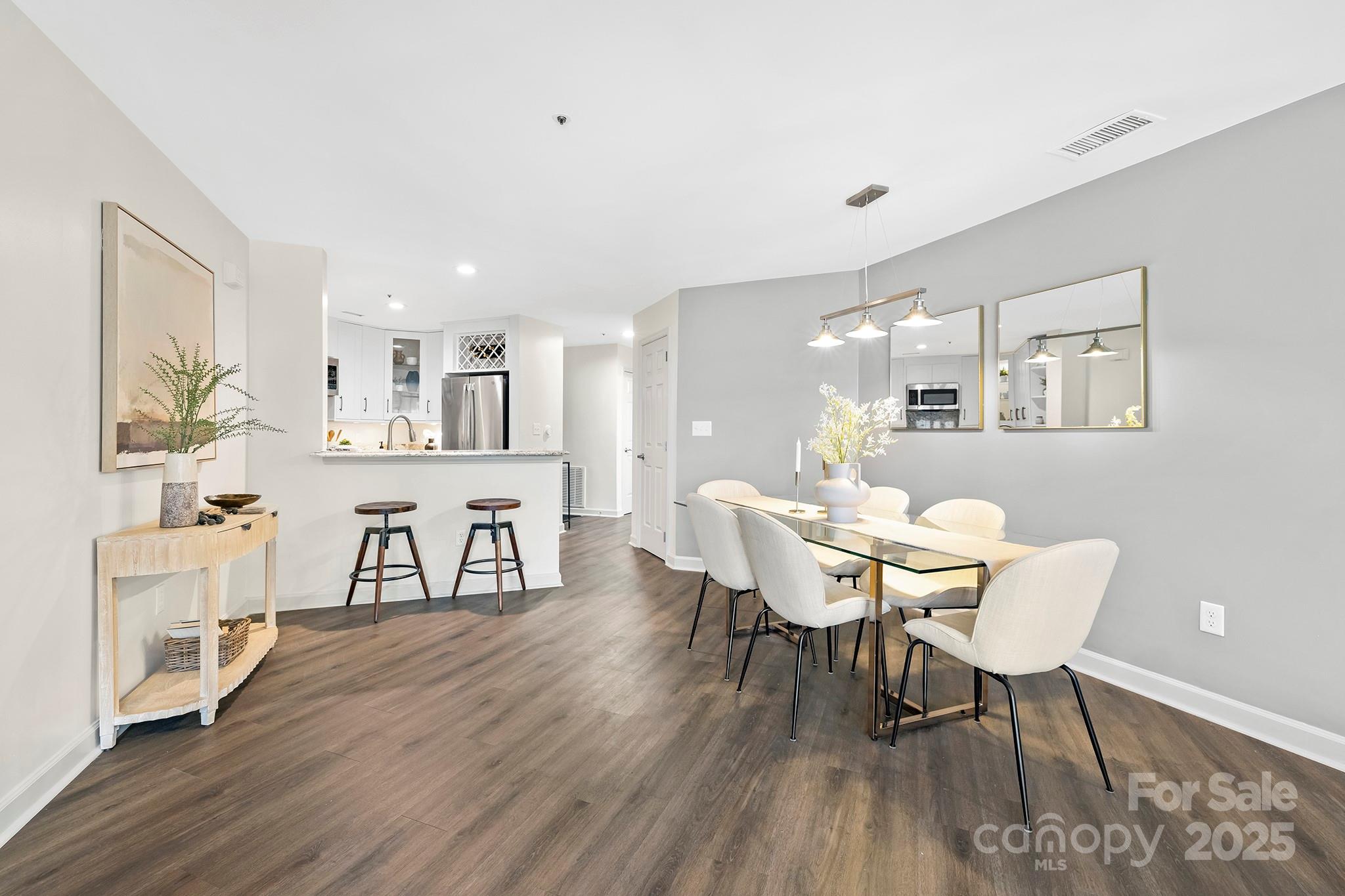 17811 Half Moon Lane, Unit E Cornelius, NC 28031 - Photo 15 of 42 a view of a dining room with furniture and wooden floor