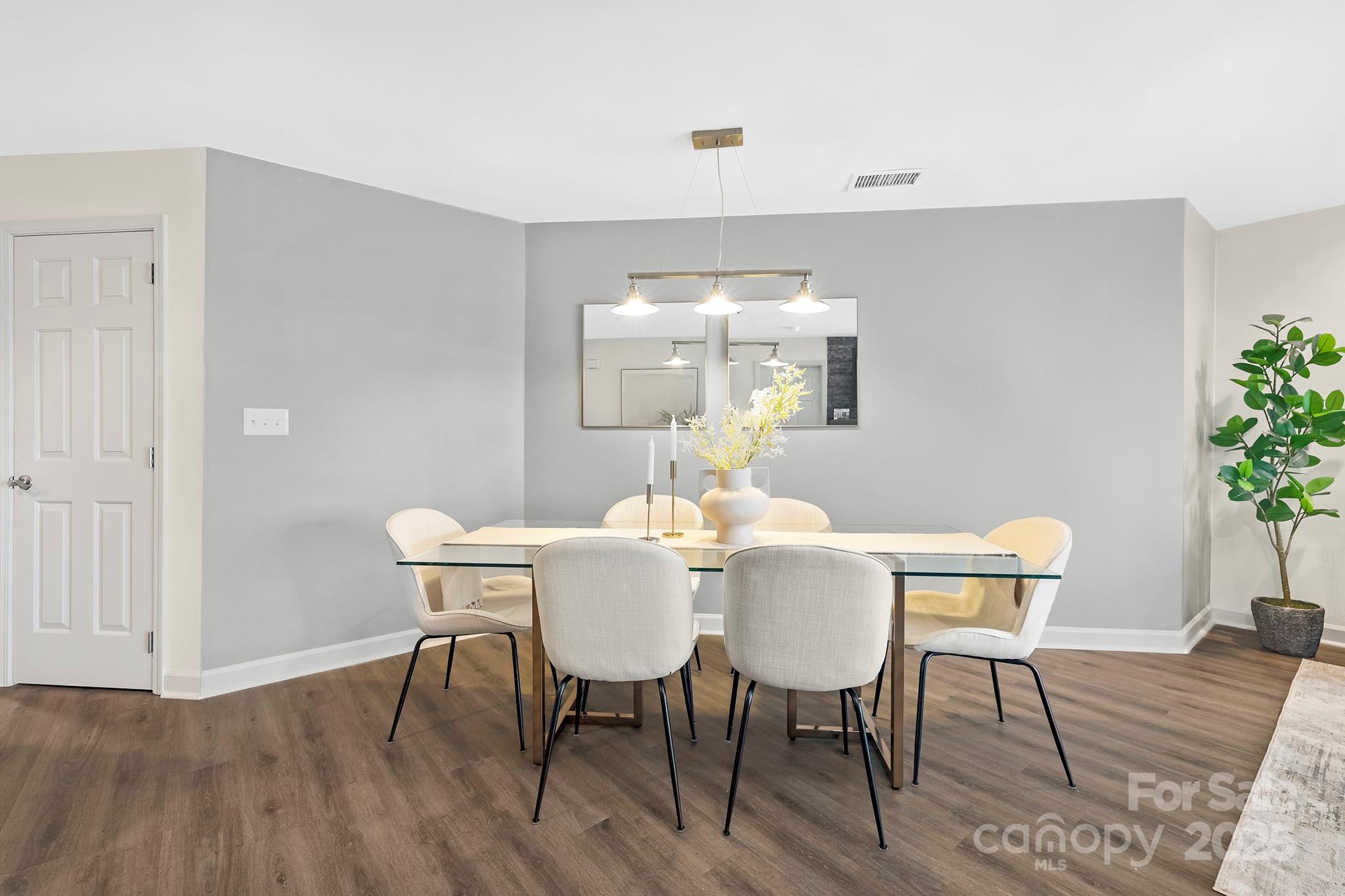 17811 Half Moon Lane, Unit E Cornelius, NC 28031 - Photo 16 of 42 a view of a dining room with furniture and wooden floor