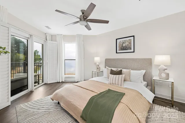 a bedroom with a large bed and a chandelier
