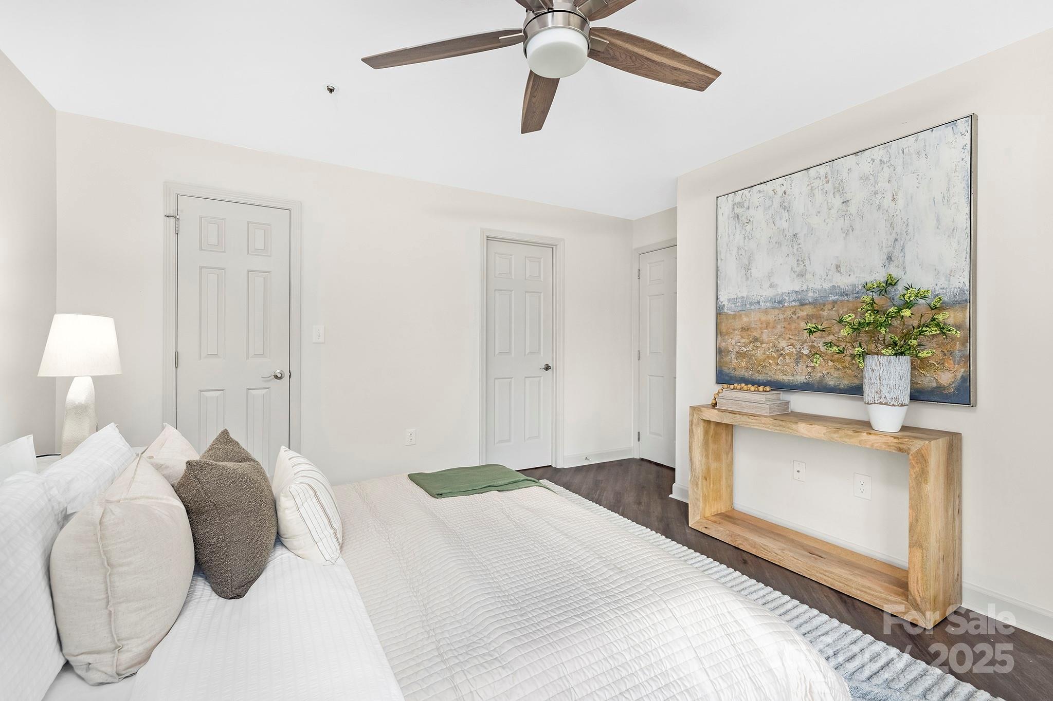 17811 Half Moon Lane, Unit E Cornelius, NC 28031 - Photo 20 of 42 a bedroom with a bed and a chandelier