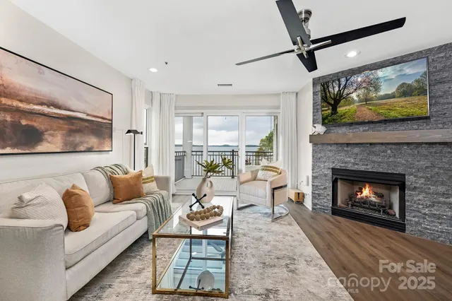 a living room with furniture a flat screen tv and a fireplace