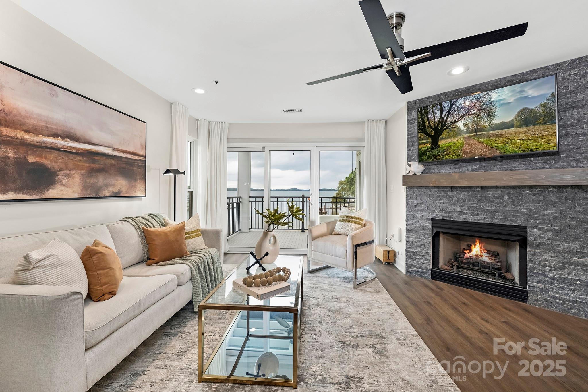 17811 Half Moon Lane, Unit E Cornelius, NC 28031 - Photo 2 of 42 a living room with furniture a flat screen tv and a fireplace