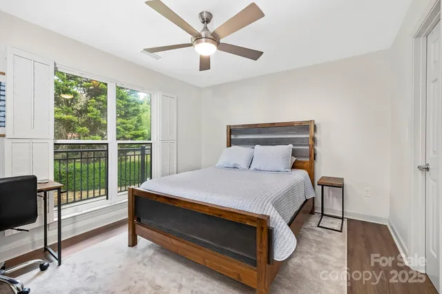 a bed sitting in a bedroom next to a window