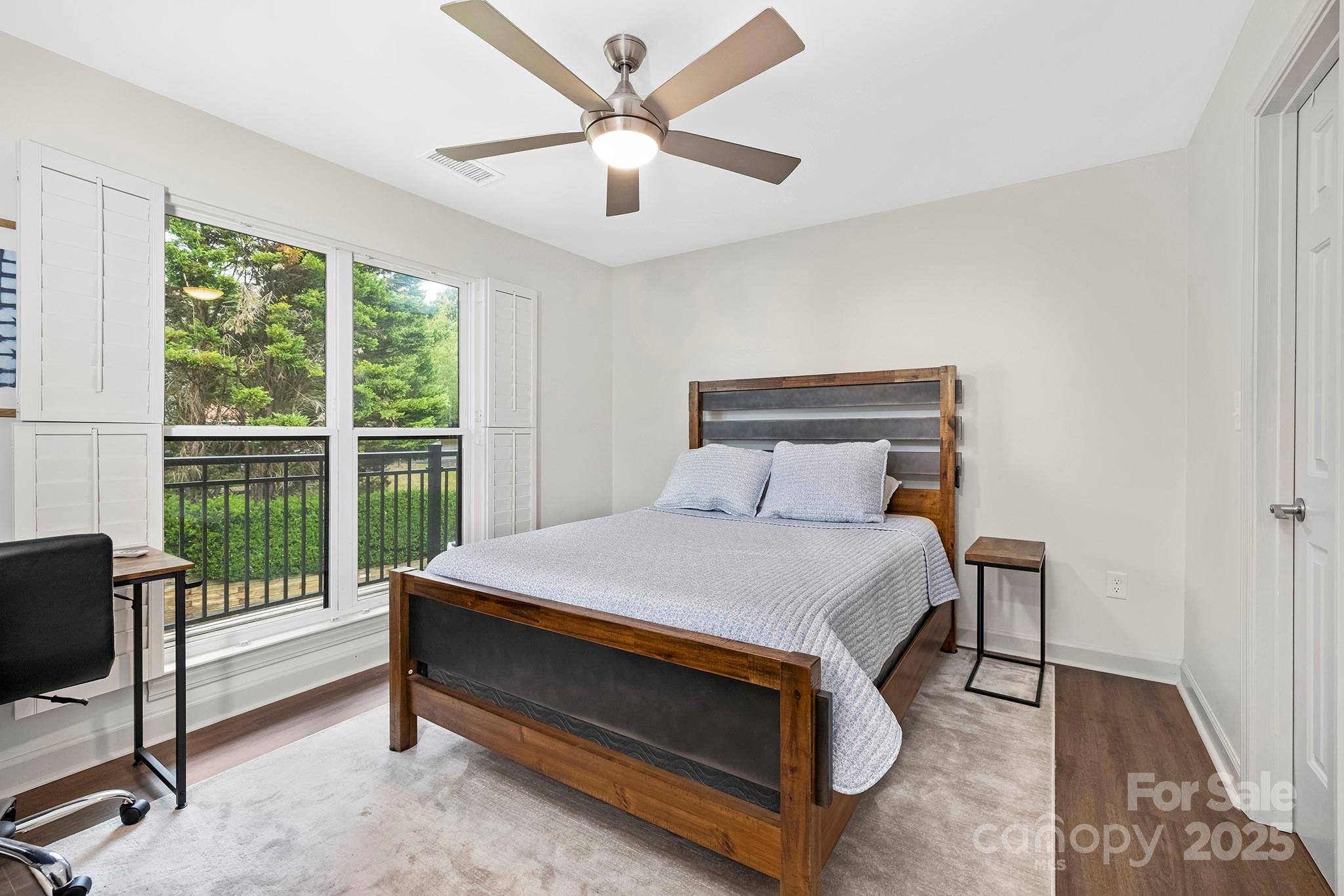 17811 Half Moon Lane, Unit E Cornelius, NC 28031 - Photo 23 of 42 a bed sitting in a bedroom next to a window