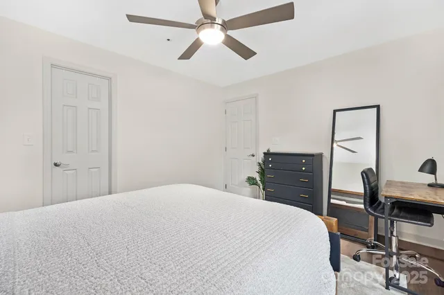 a bedroom with a bed and a chandelier