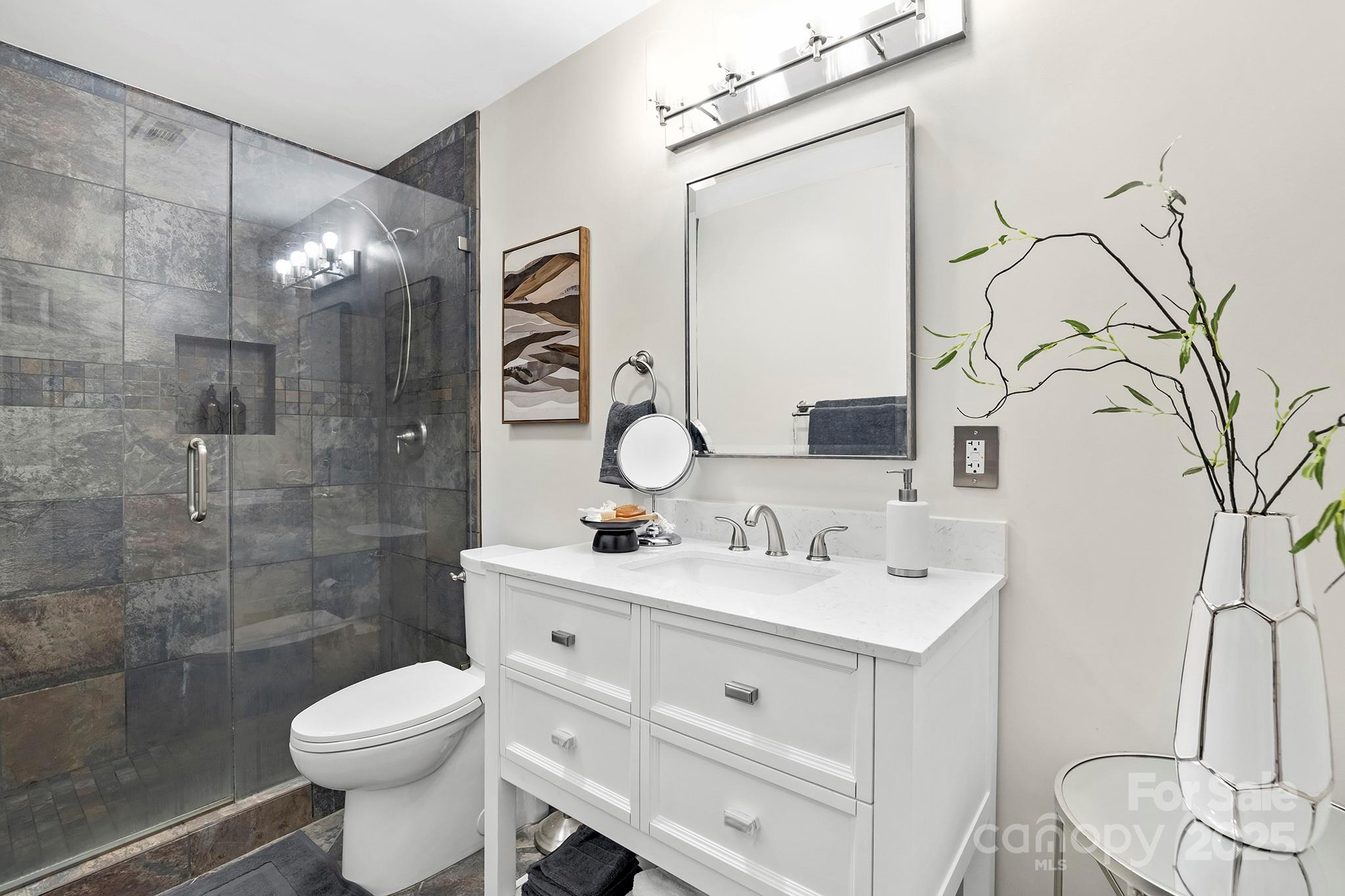 17811 Half Moon Lane, Unit E Cornelius, NC 28031 - Photo 25 of 42 a bathroom with a sink vanity toilet and shower
