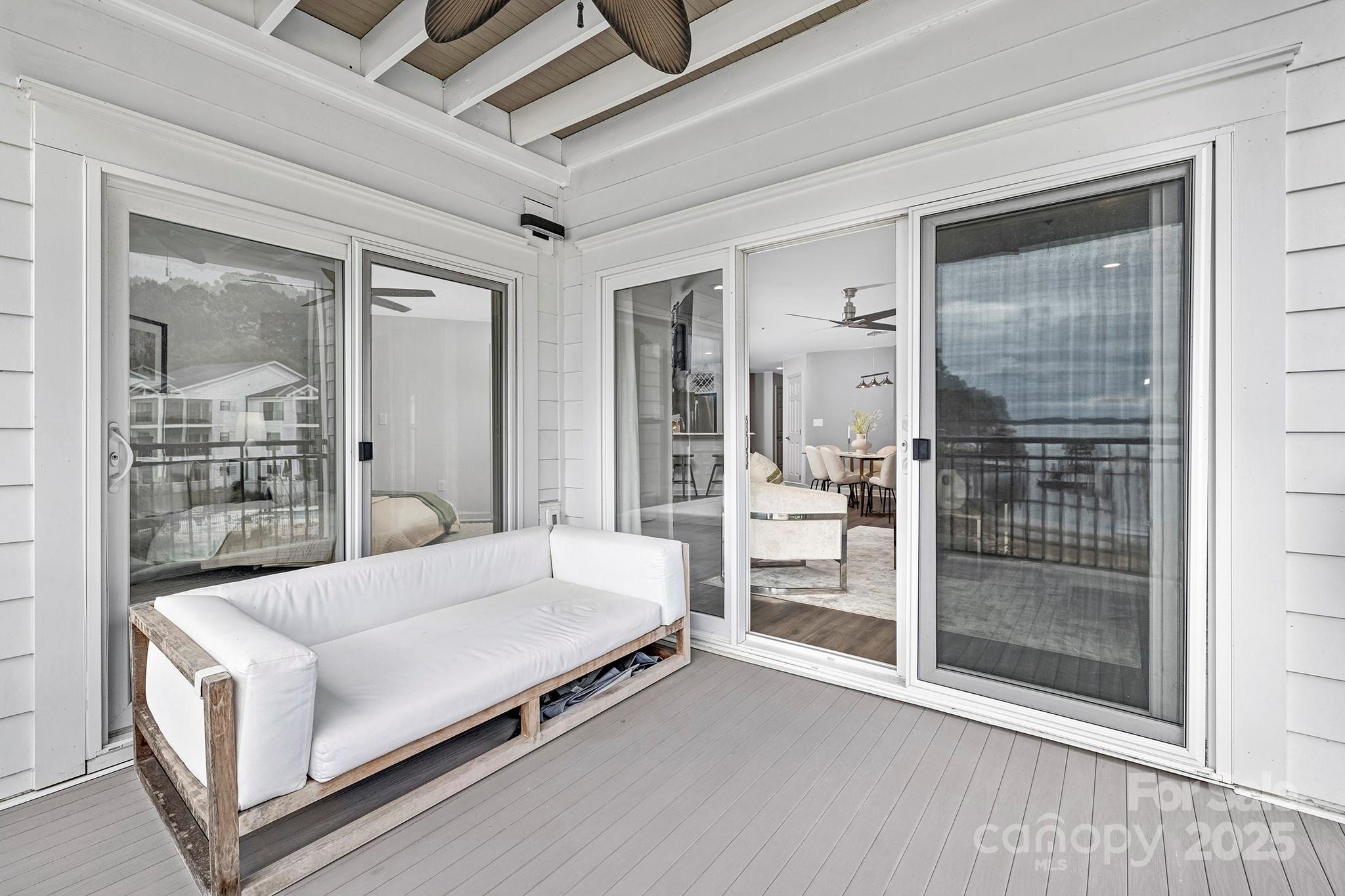 17811 Half Moon Lane, Unit E Cornelius, NC 28031 - Photo 27 of 42 a living room with a bed and glass door