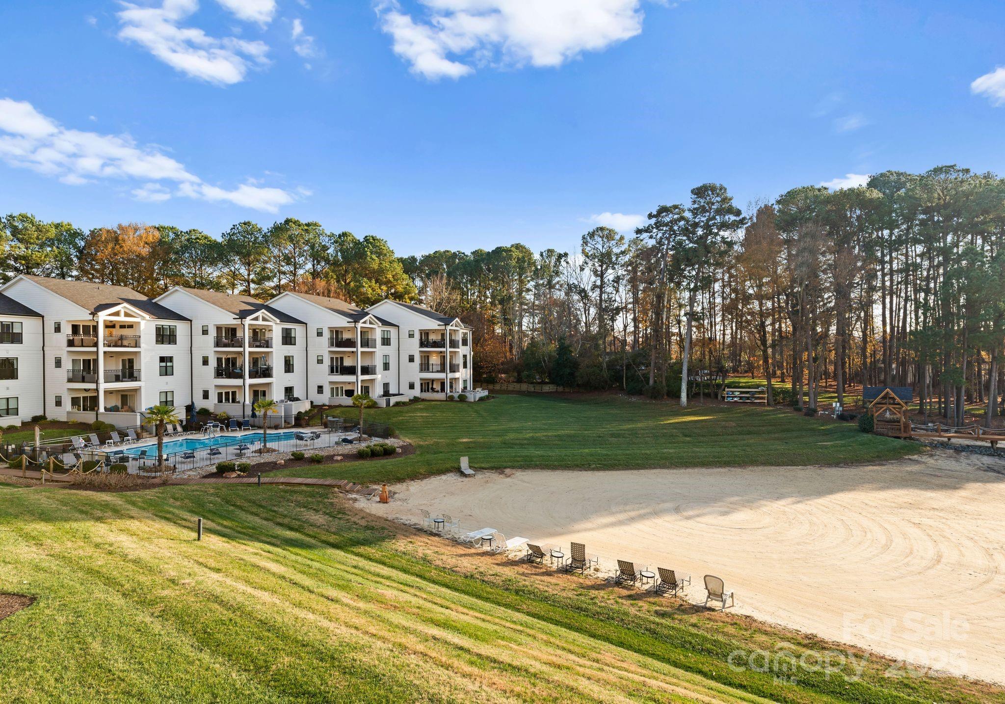 17811 Half Moon Lane, Unit E Cornelius, NC 28031 - Photo 31 of 42 a view of swimming pool with outdoor seating and trees in the background