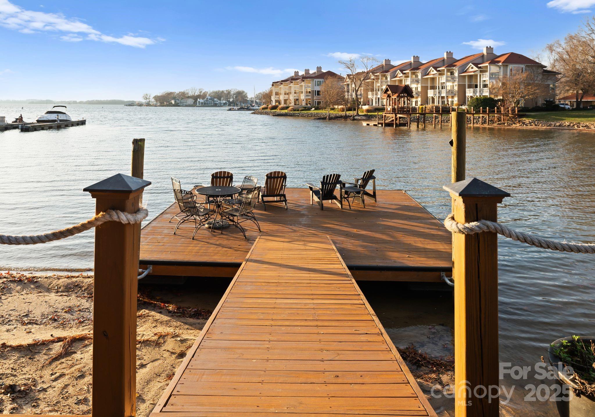 17811 Half Moon Lane, Unit E Cornelius, NC 28031 - Photo 41 of 42 a view of a lake with boats and trees in the background