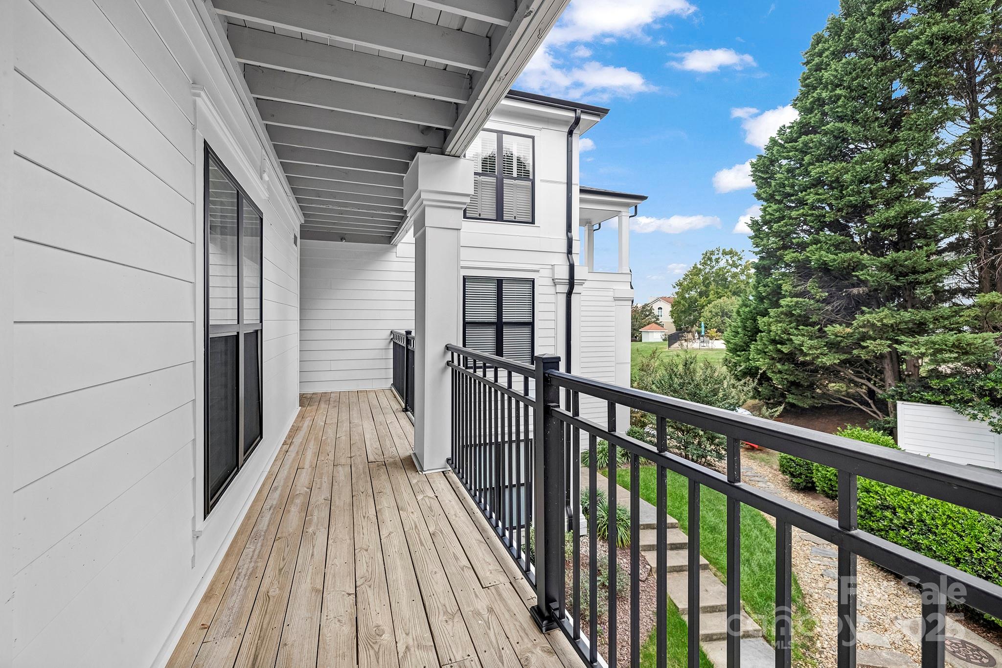 17811 Half Moon Lane, Unit E Cornelius, NC 28031 - Photo 10 of 42 a view of a balcony with wooden floor