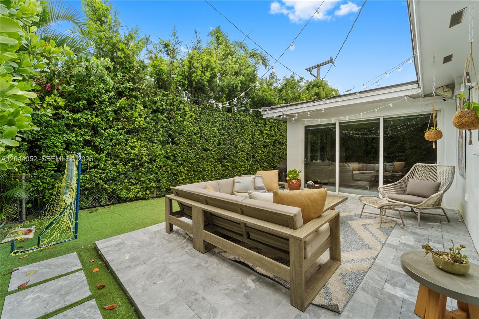 721 Bird Road Coral Gables, FL 33146 - Photo 19 of 24 a patio with table and chairs and potted plants