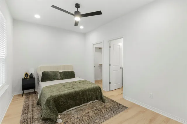 a bedroom with a bed and a potted plant