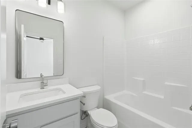 an empty room with windows and ceiling fan